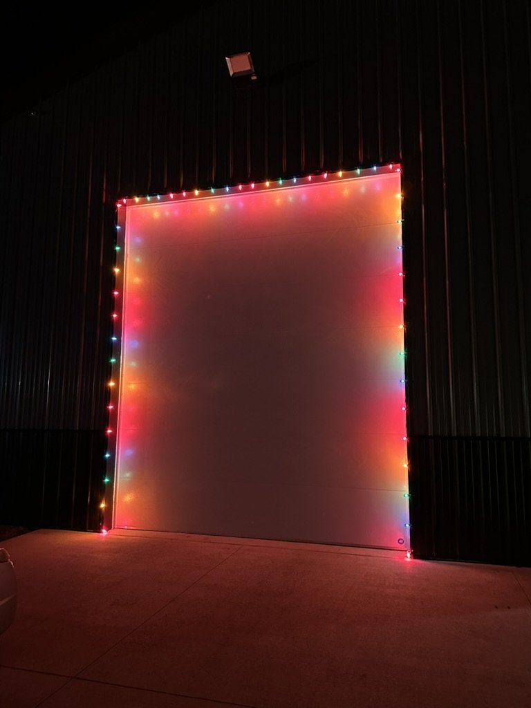 Garage door outlined in multicolor lights at night